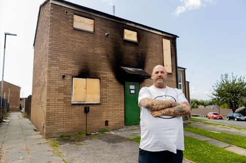 Andrew outside his home after it was destroyed by the blaze earlier this year