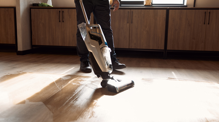 A steam cleaner being used on an induction hob