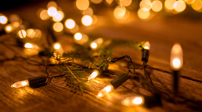 Christmas lights on wooden flooring.