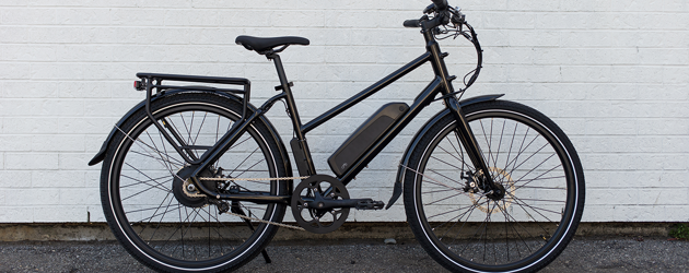 Black Electric Bicycle Against White Brick Wall