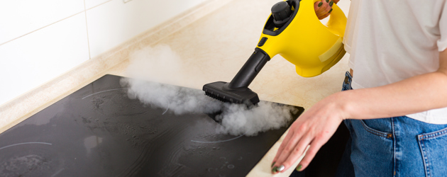 Steam Cleaner Being Used On Induction Hob