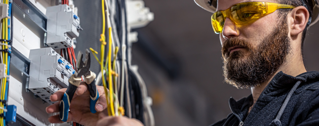 Electrician Working On Fuses