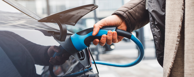 Man Charging Electric Vehicle