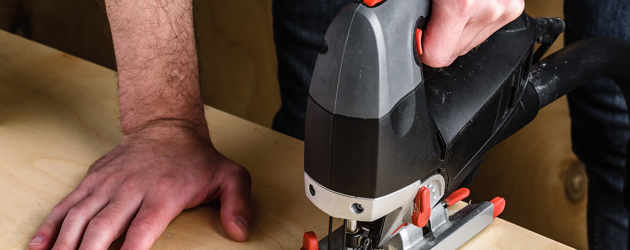 Man Using Electric Jigsaw