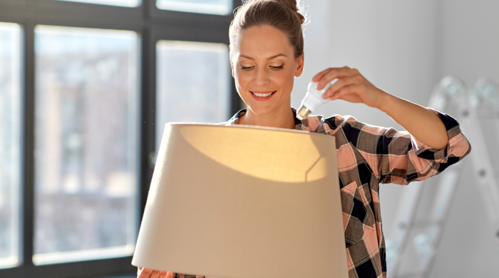 A woman changing a bulb